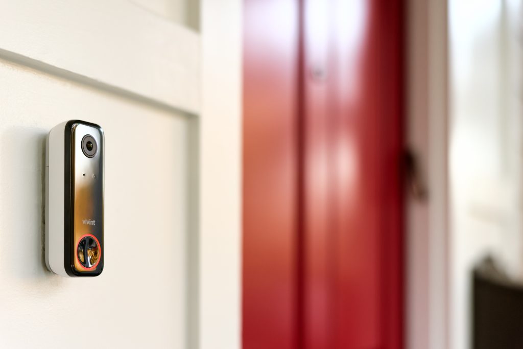 Vivint pro doorbell mounted on white siding