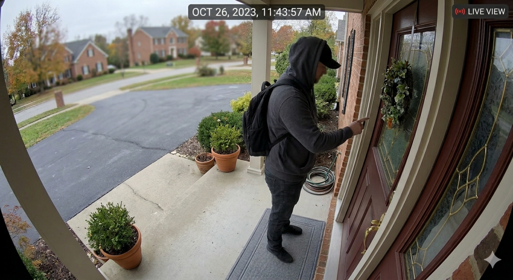 Doorbell camera view of unknown person at front door